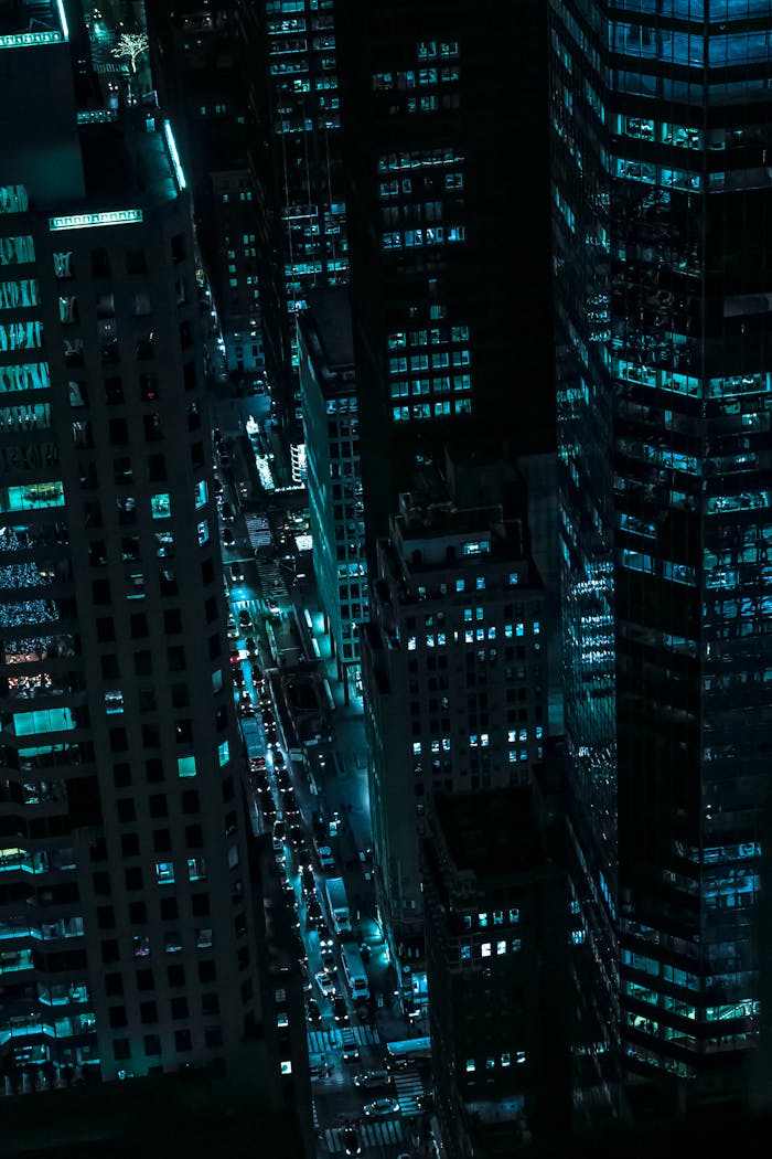 Captivating aerial view of illuminated skyscrapers in New York City during the night.